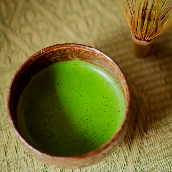 Freshly whisked usucha made with organic Okumidori ceremonial matcha, with chasen visible