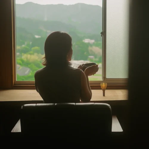 Quiet moment holding usucha by the window, reflecting a personal matcha journey
