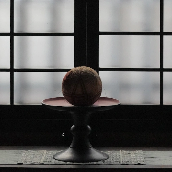 Traditional Japanese temari balls placed by the window at the Kawai Kanjiro Memorial House in Kyoto